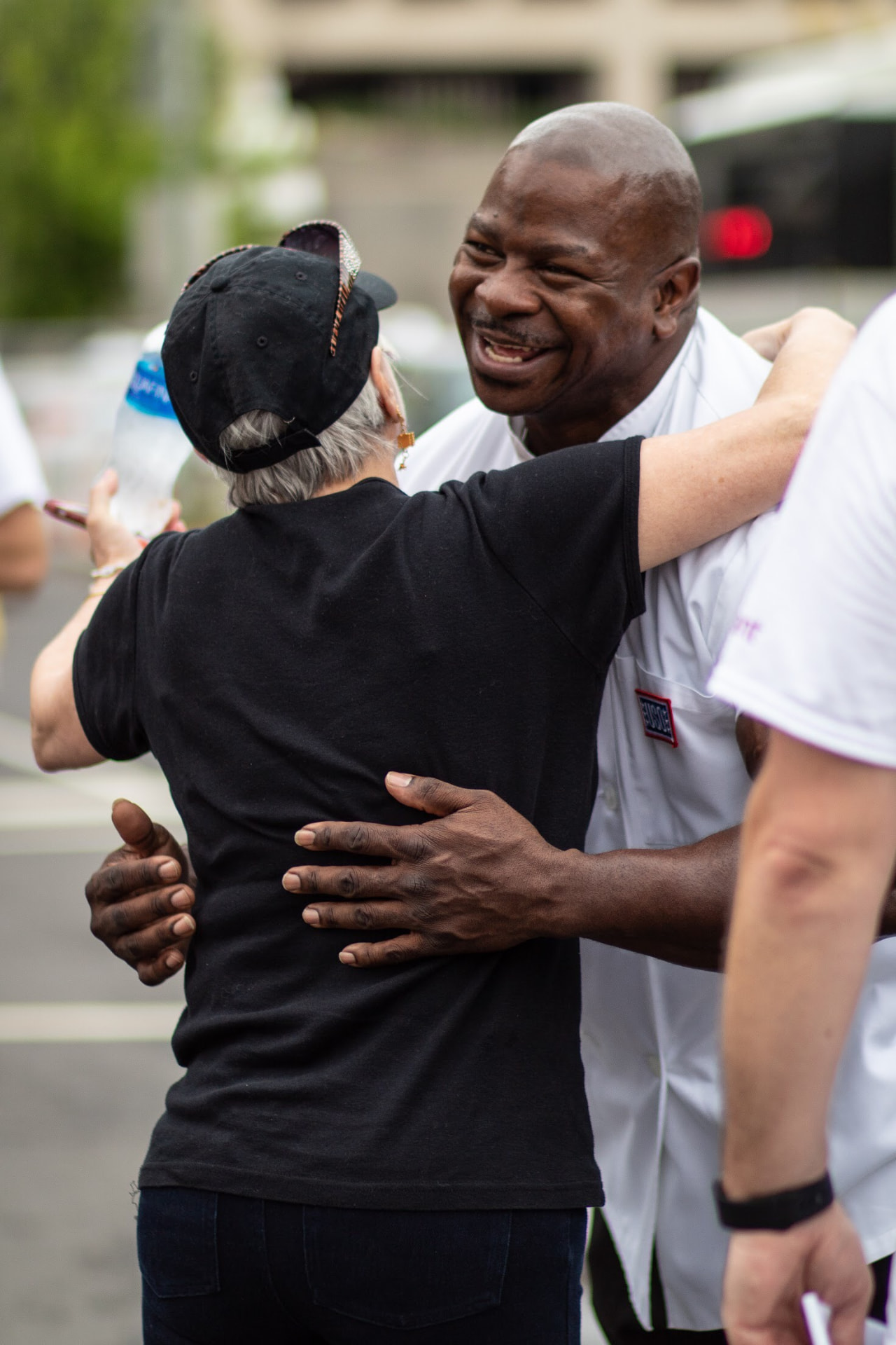Chef Andre Rush embracing a community member