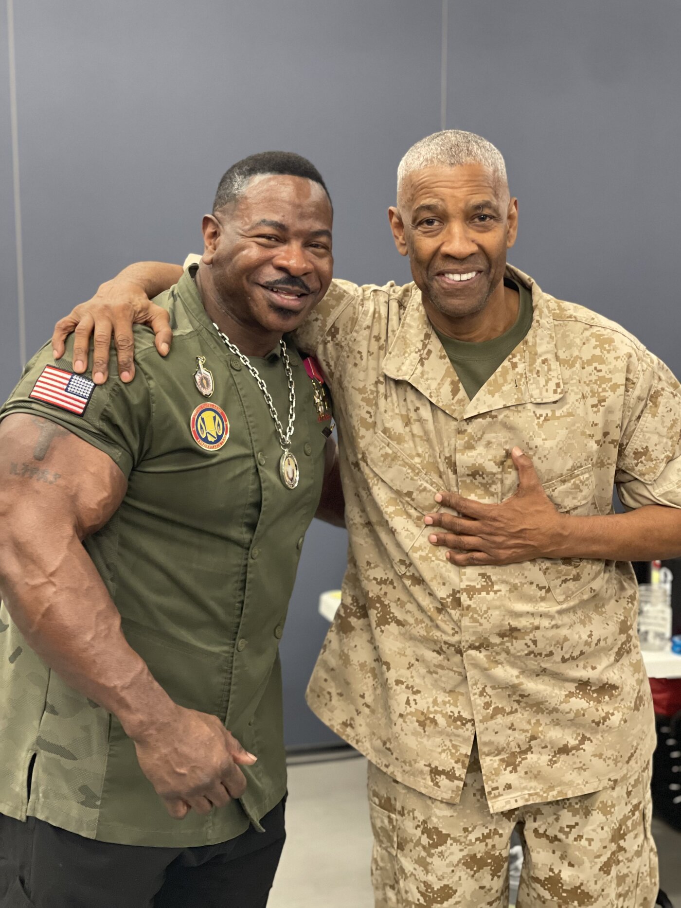 Chef Andre Rush with a service member in desert camouflage uniform